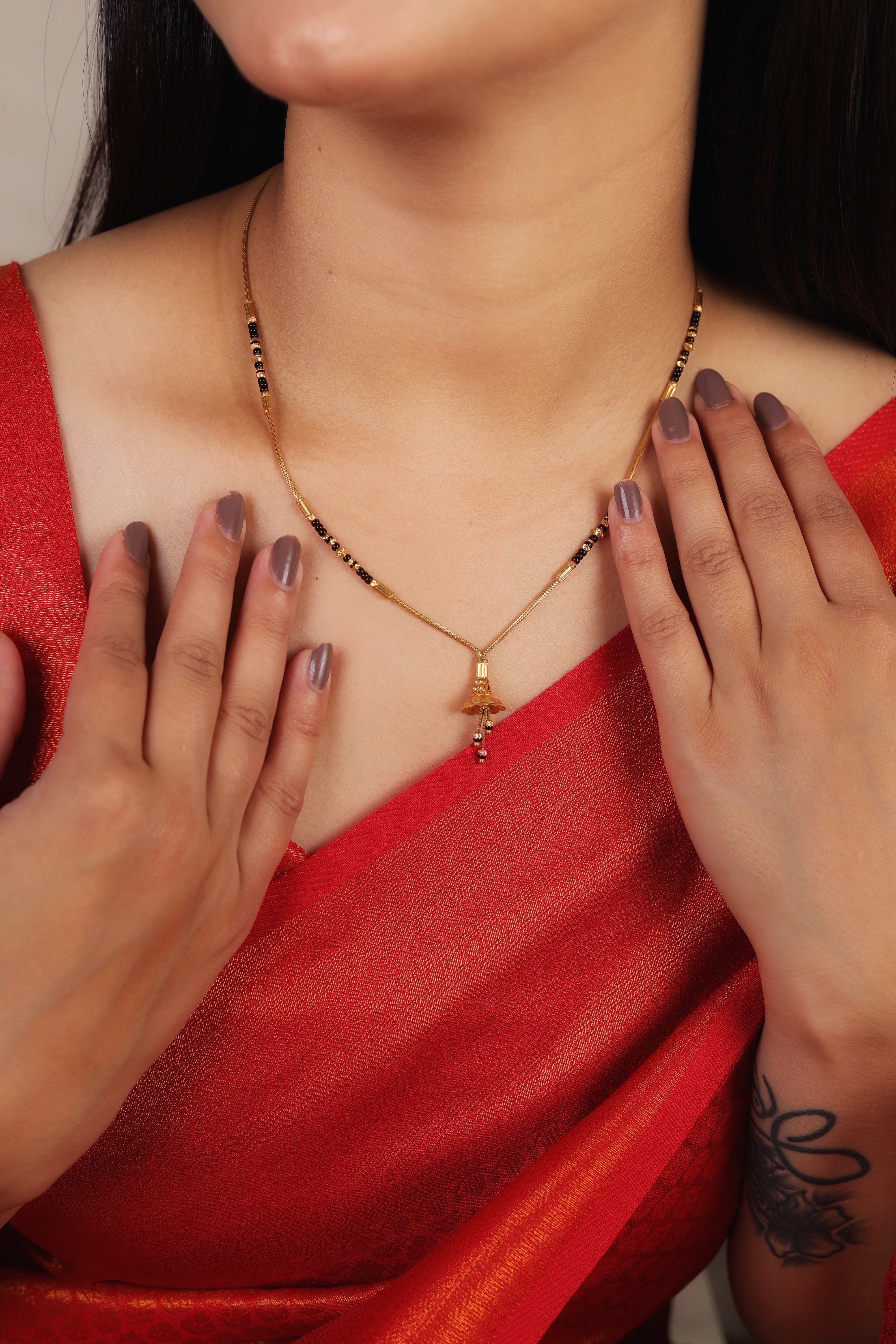Elegant Golden Bell Short Mangalsutra with Slender Link Chain and Black Bead Accents
