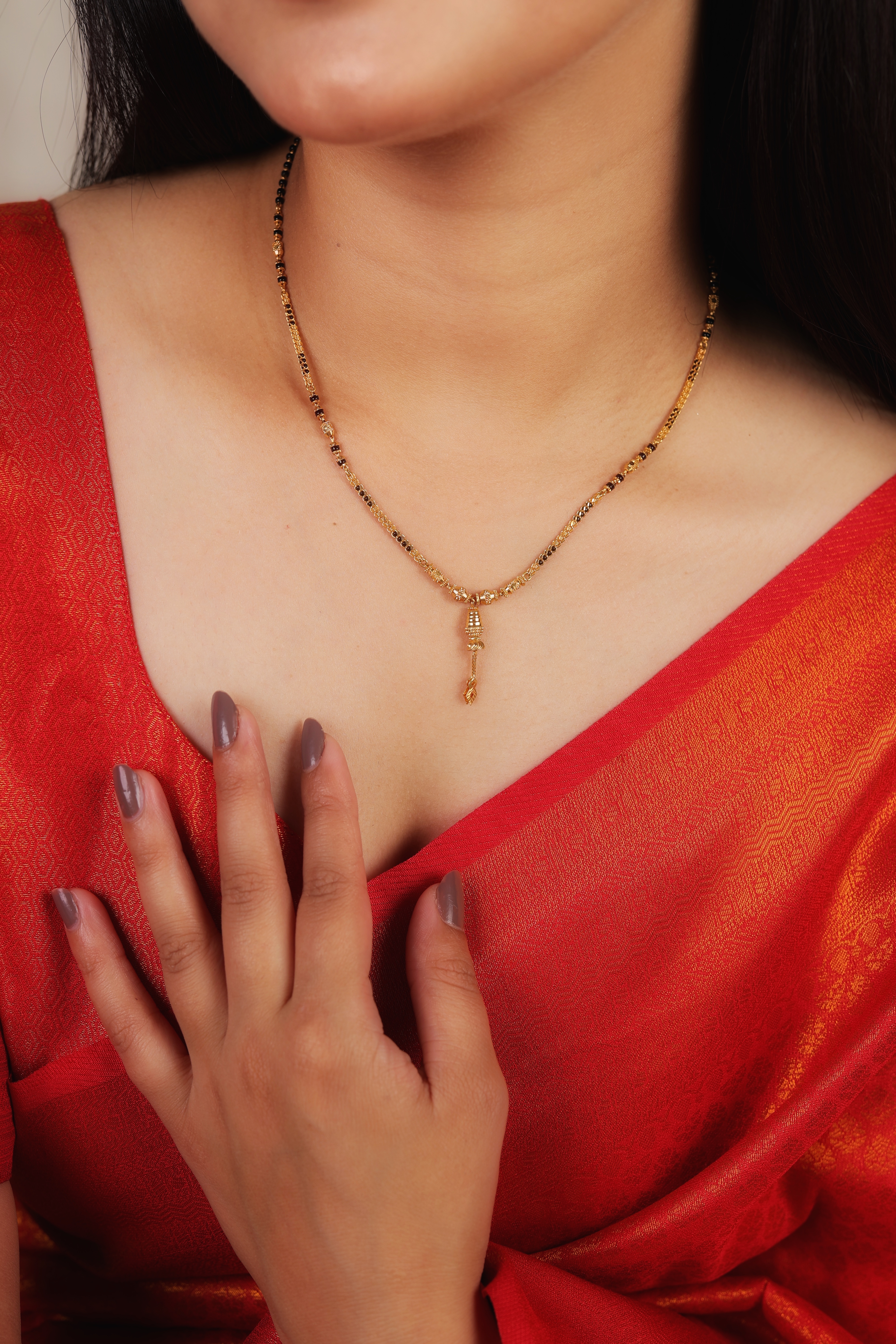 Contemporary 22K Gold Short Mangalsutra with Tiered Cylindrical Pendant and Leaf-Detail Tassel