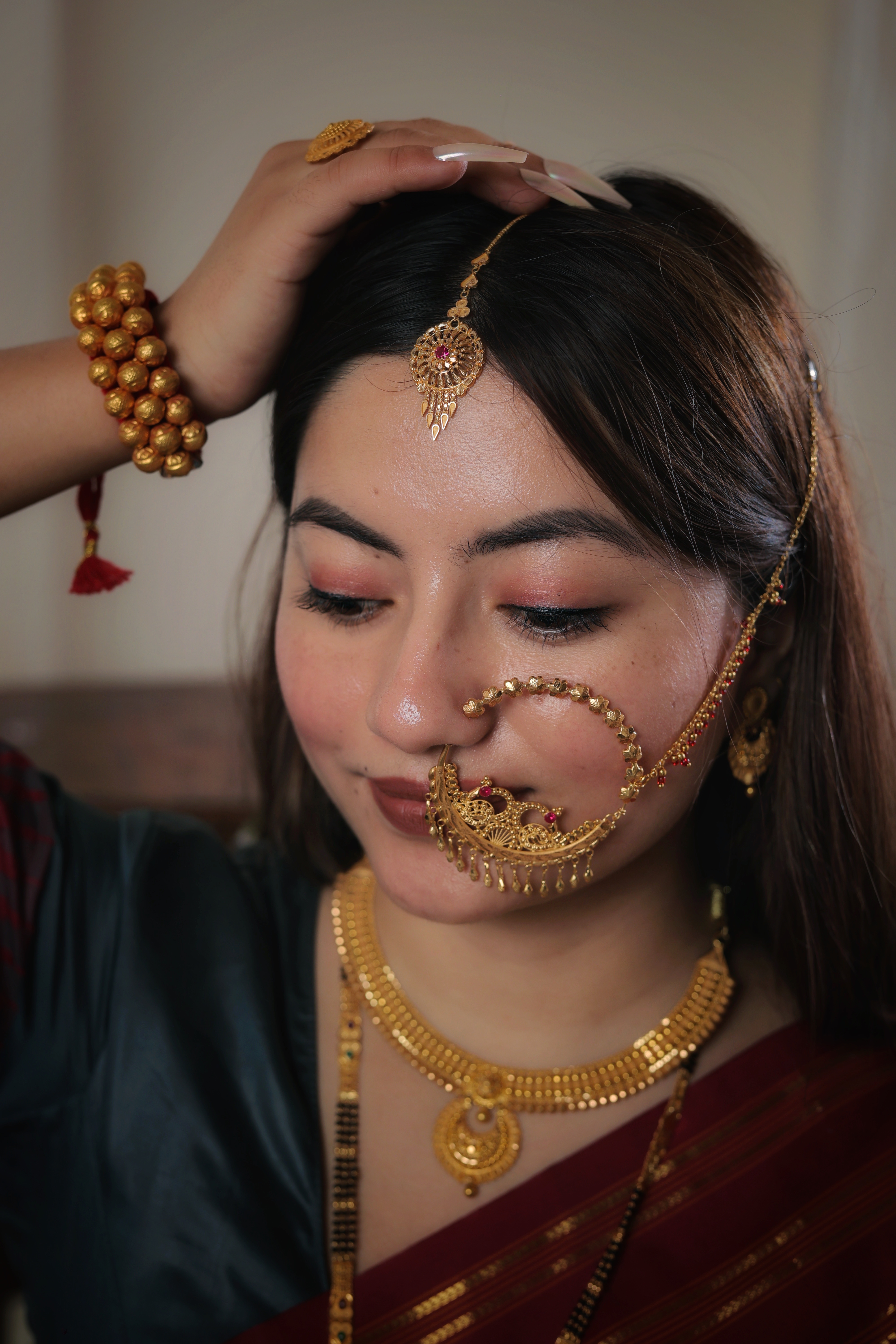 Ornate 22K Gold Circular Maang Tika with Central Ruby and Intricate Filigree Work